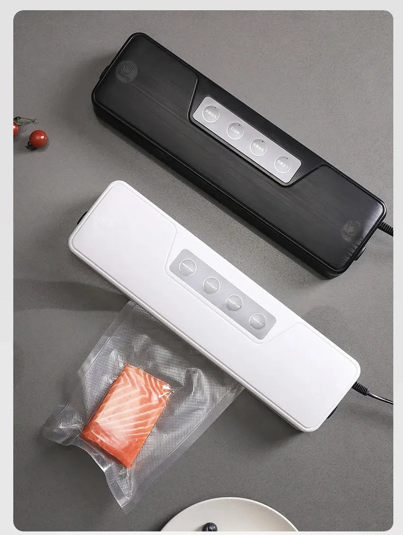 Black compact automatic vacuum sealer machine for food preservation on a kitchen counter.