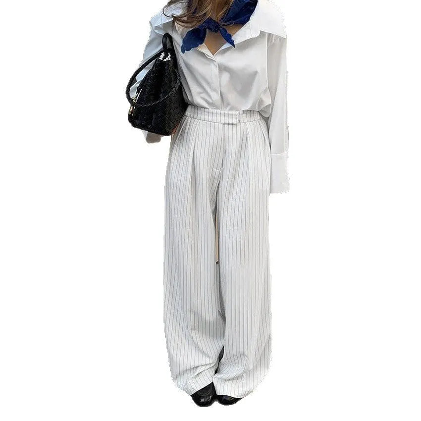 White striped wide-leg casual trousers with zipper closure on mannequin
