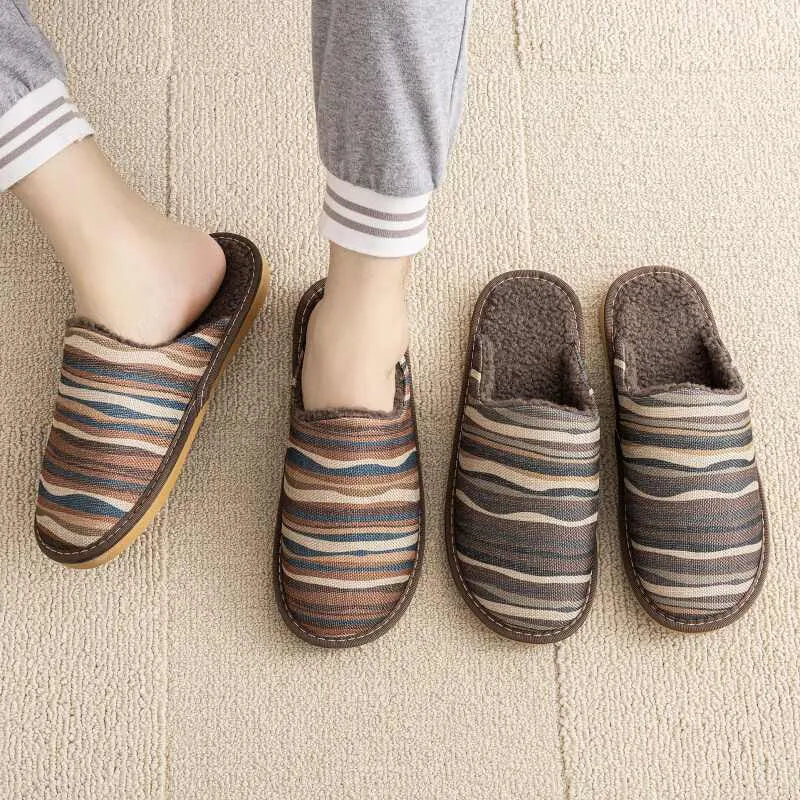 Warm winter linen surface household cotton slippers with PVC sole in gold coffee/cotton colour on a wooden floor