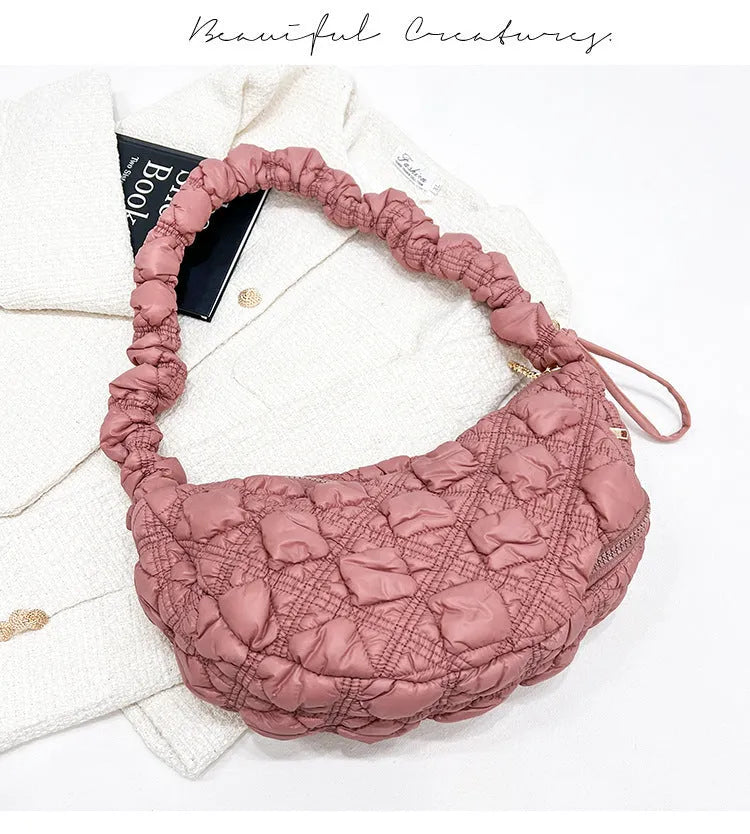 Women's light beige nylon underarm messenger bag with a long shoulder strap.