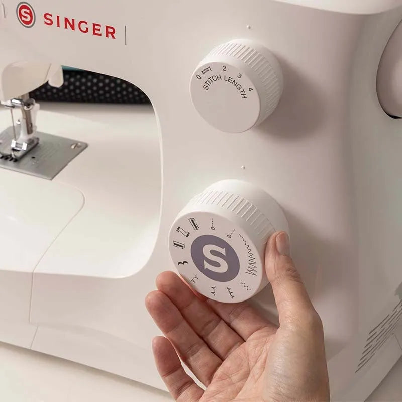 Portable household sewing machine M2405 on a table, compact design, 47x39x26cm, for thick fabric sewing