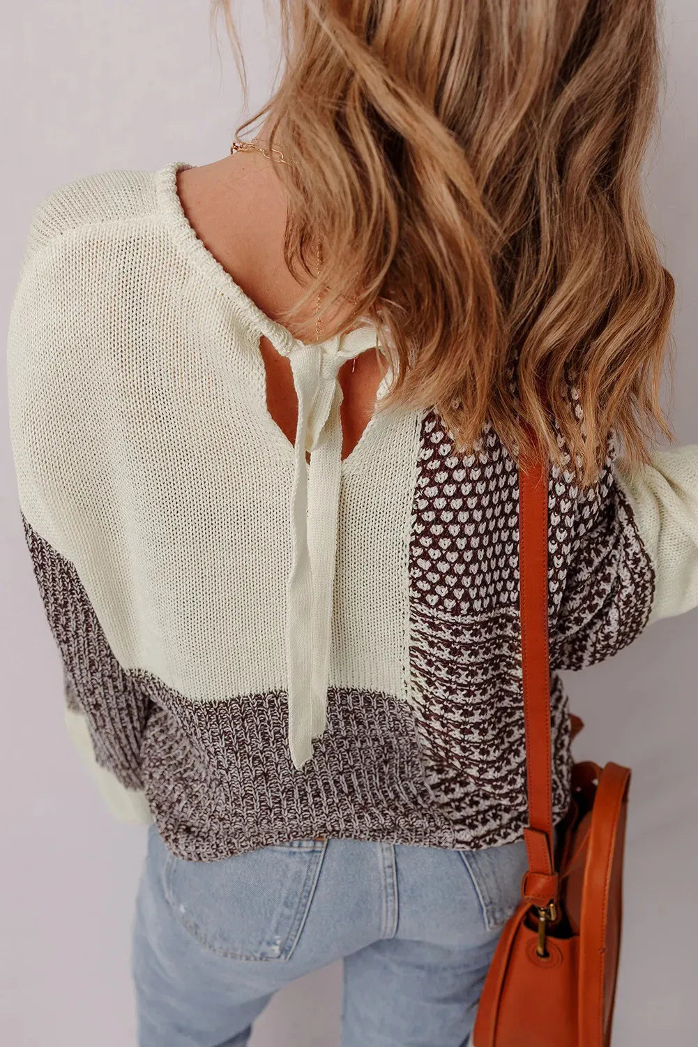 Dark khaki women's loose sweater with back tie closure and drop shoulders.