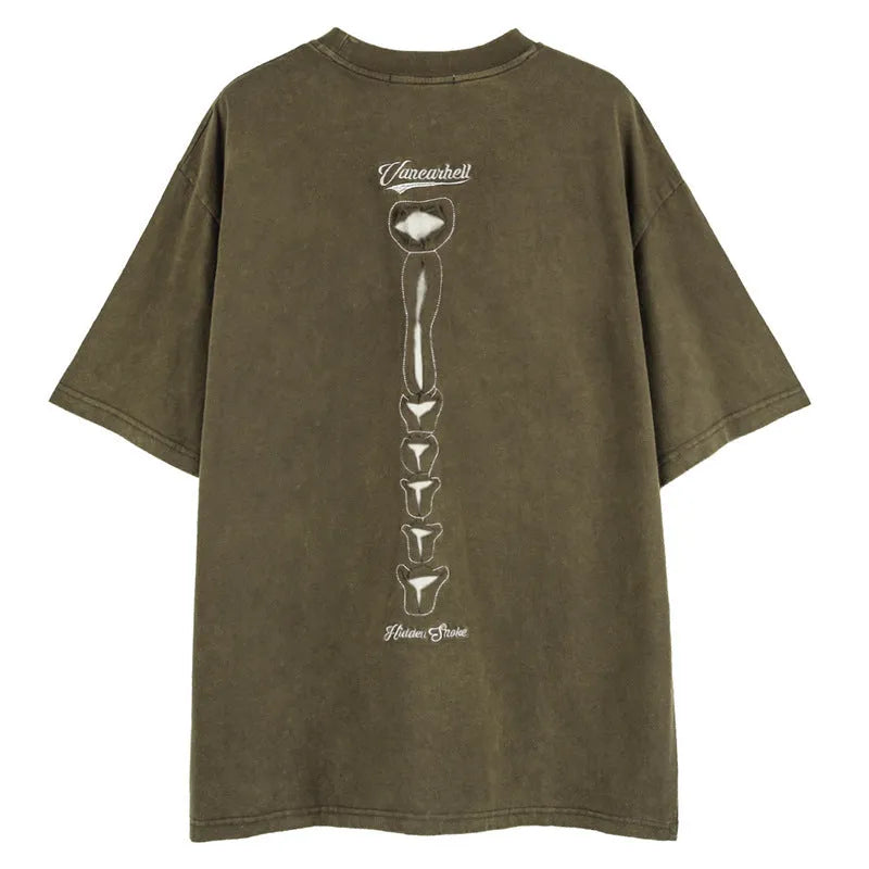 Man modelling a loose black cotton pullover with a white skull and letter graphic print on the front.