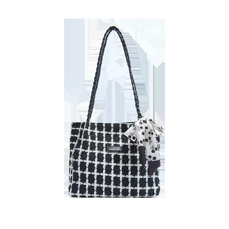 Black woven wool shoulder bag with horizontal square shape showing internal organiser compartments