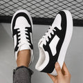 Black women's rubber casual sports shoes with flat heel, low top, round toe, and front lace-up closure