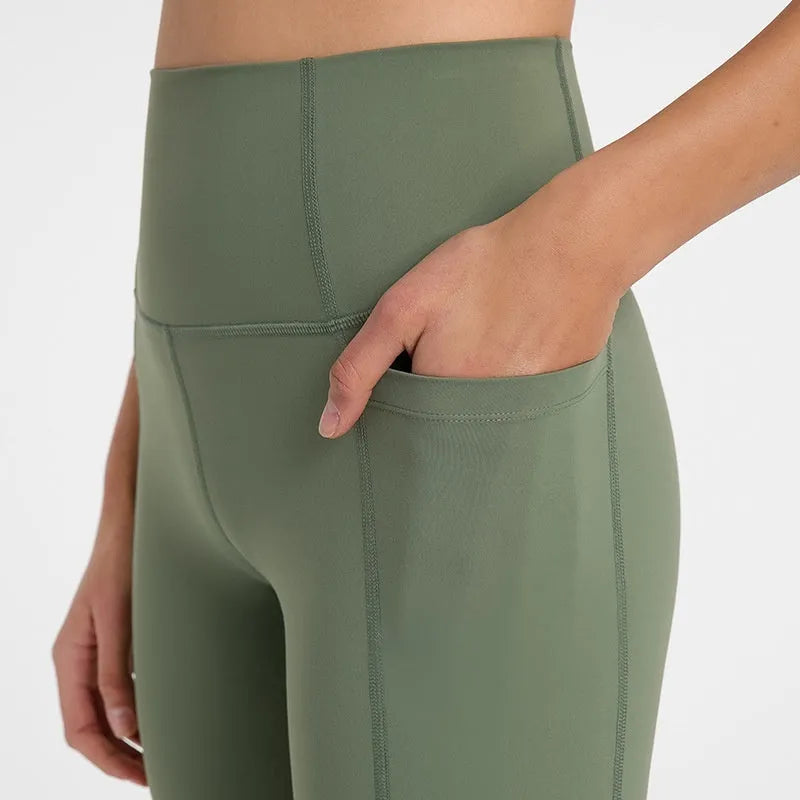 Women's tight-fitting mid-thigh sports shorts in grey lake green for fitness.