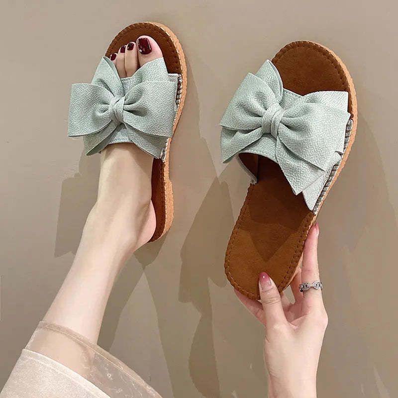 Women's slip-on suede sandals with bow detail, flat heel, rubber sole – beige colour option