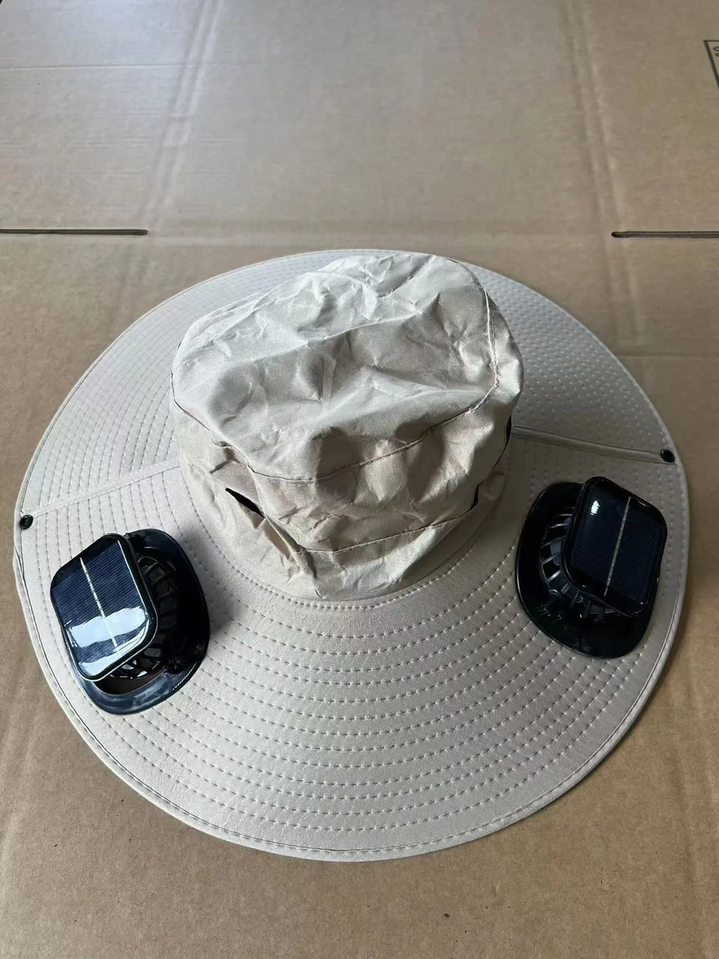 Men's grey solar fan cap with large brim and built-in fan on a sunny background