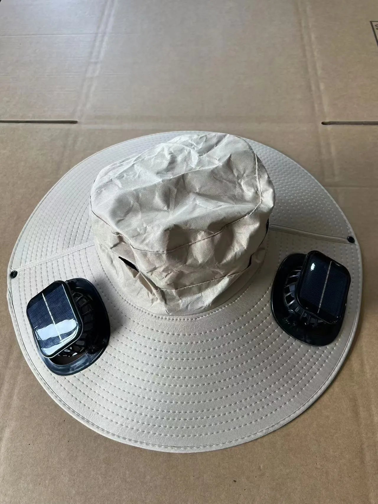 Men's grey solar fan cap with large brim and built-in fan on a sunny background