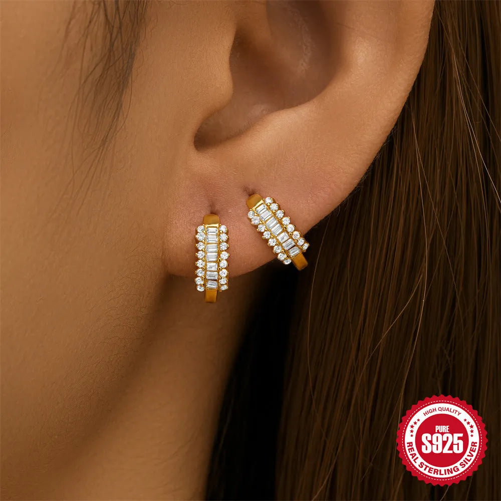 Small round geometric sterling silver stud earrings with an electroplated gold or silver finish.