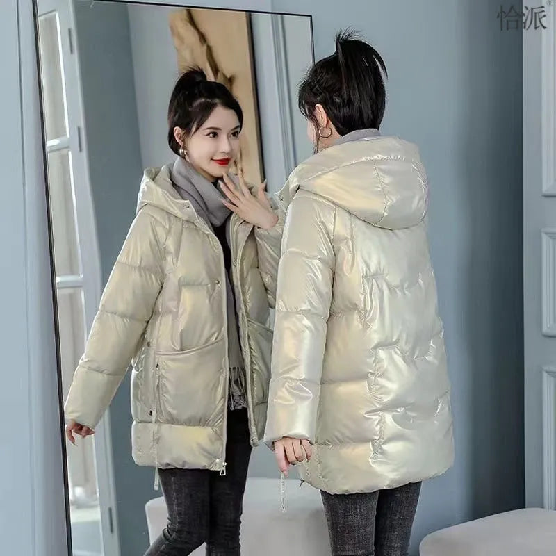 A loose-fitting, thick hooded winter jacket for women in a champagne colour, showcasing long sleeves.