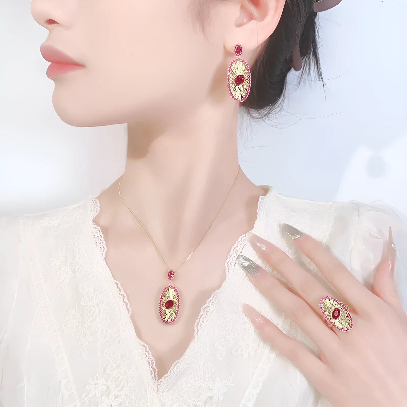Gold-plated jewellery set with simulated red corundum stones, water drop shape, diamond cut finish, necklace ring ear studs