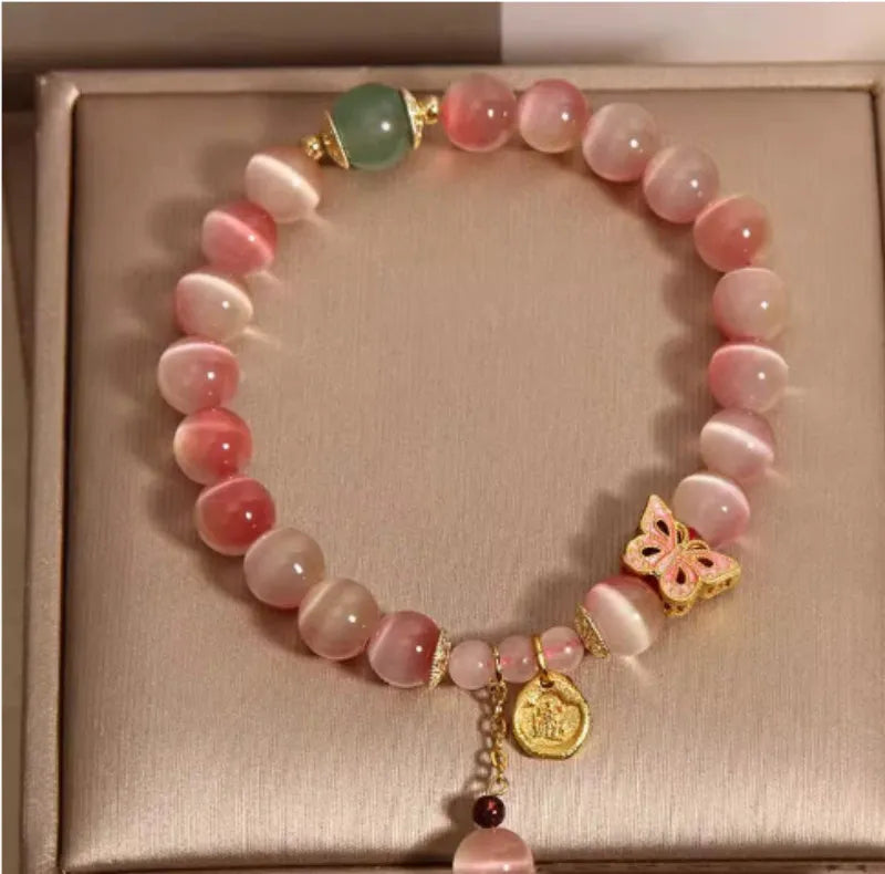 Pink opal butterfly women's bracelet with electroplated finish, Chinese style, on display