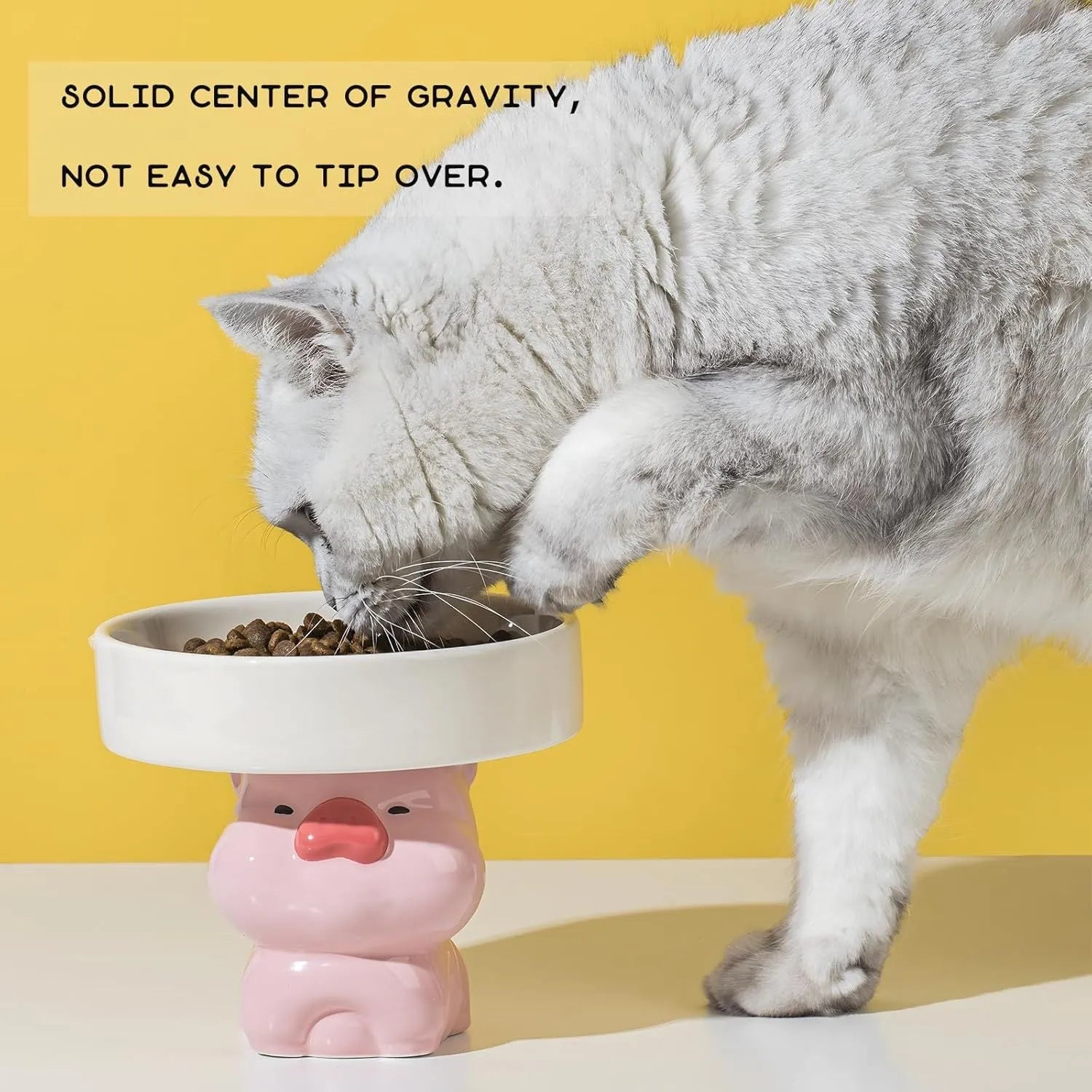A raised ceramic cat bowl in an animal design, showing its height and wide opening for whisker-friendly feeding.
