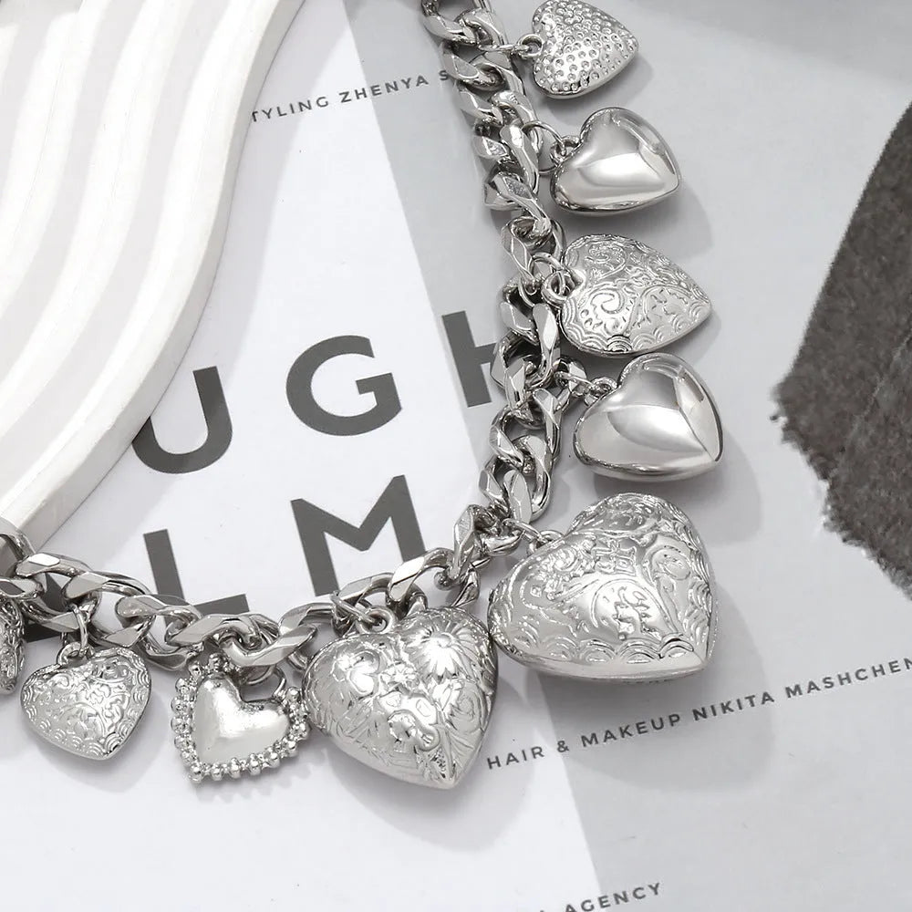 Carved heart-shaped pendant necklace on an adjustable metal chain in gold colour.