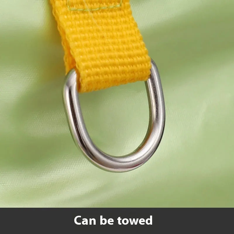 Green cotton dog coat with four-legged design and padded lining on a dog outdoors.