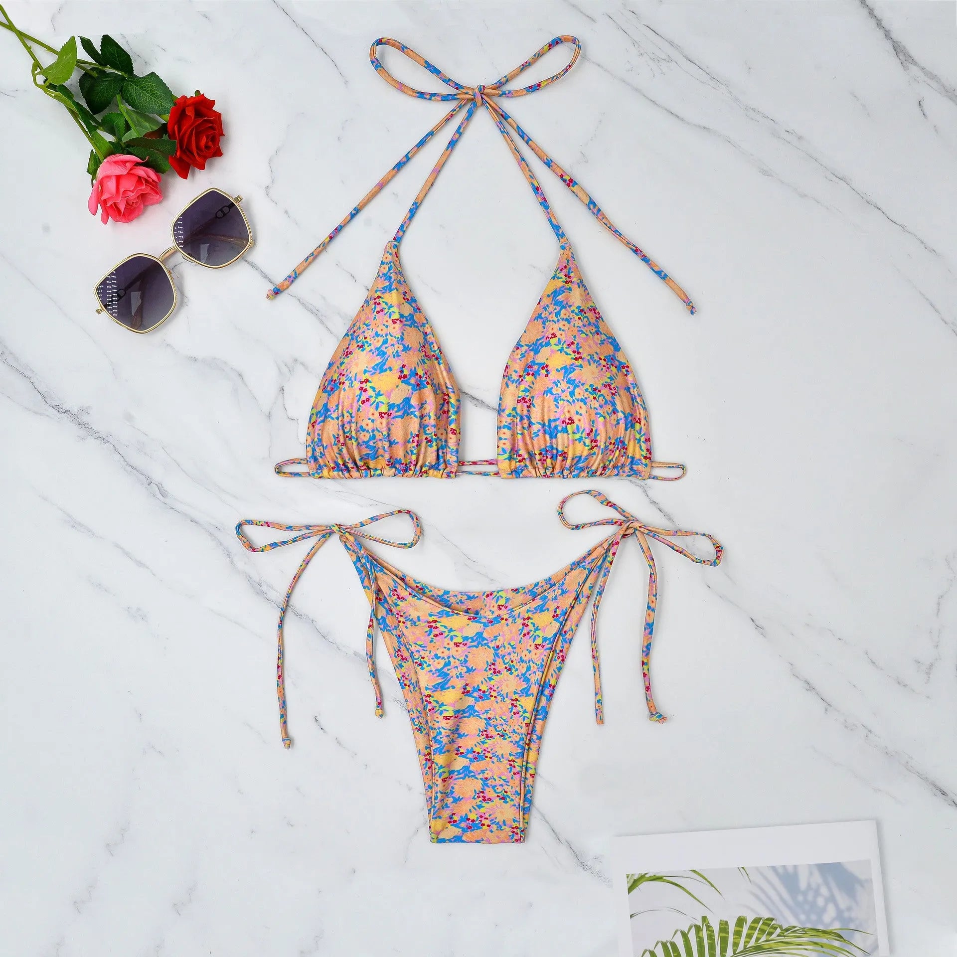A pictured colour lace-up bikini swimsuit with adjustable ties and a backless briefs design.
