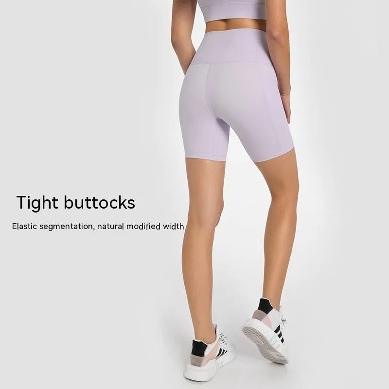 Women's tight-fitting mid-thigh sports shorts in grey lake green for fitness.