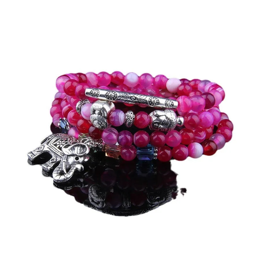 Multi-layer natural agate bracelet with 6mm beads in blue elephant pattern on a neutral background
