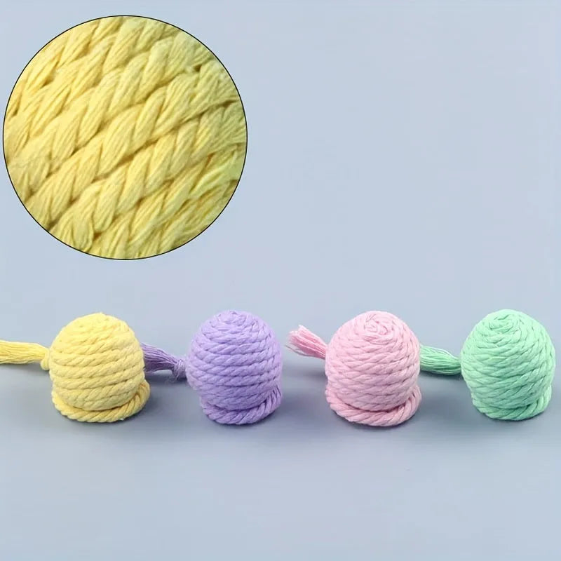 Colourful cat toy ball with attached rope and built-in bell in green, pink, purple, and yellow