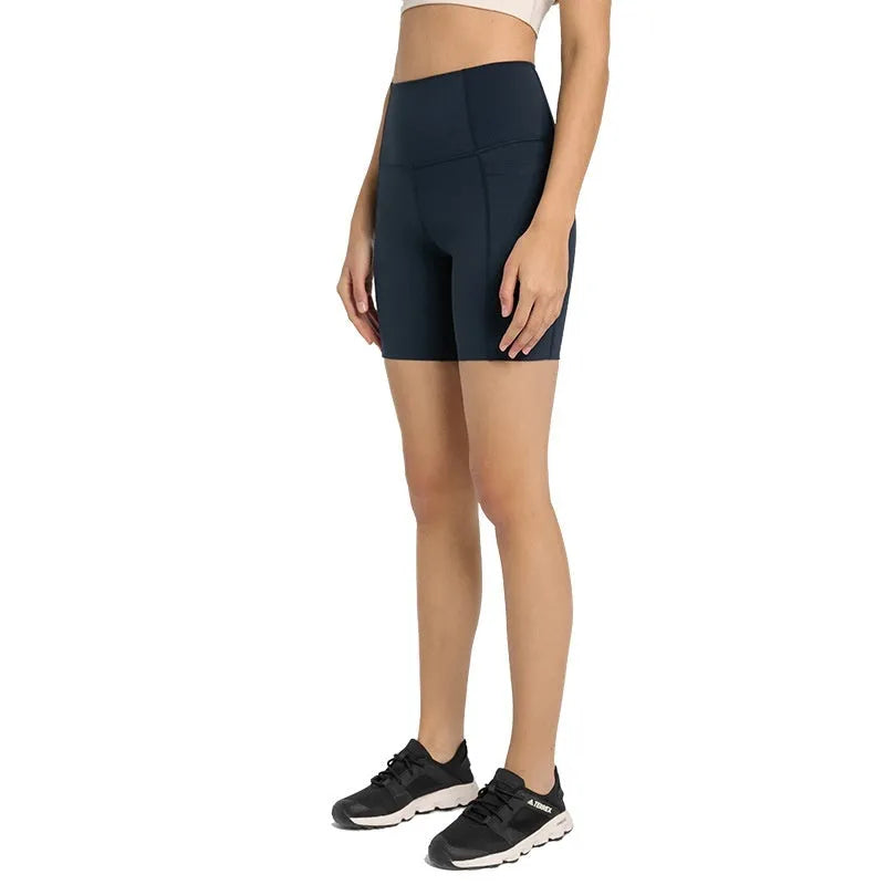 Women's tight-fitting mid-thigh sports shorts in grey lake green for fitness.