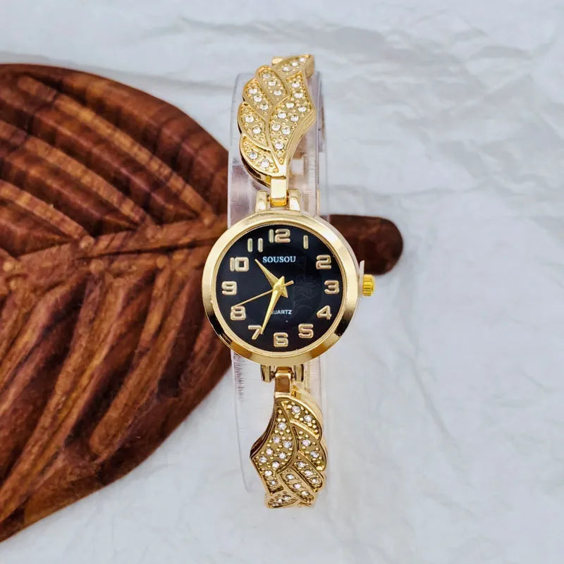 Women's stainless steel watch with round dial on wrist, showing gold surface colour option.