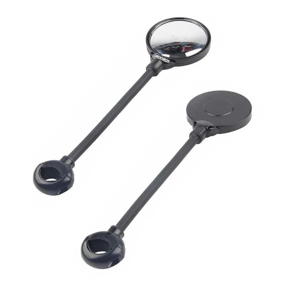 Close-up of a black metal bicycle rearview mirror with hose adjustment mechanism and reflector on a handlebar