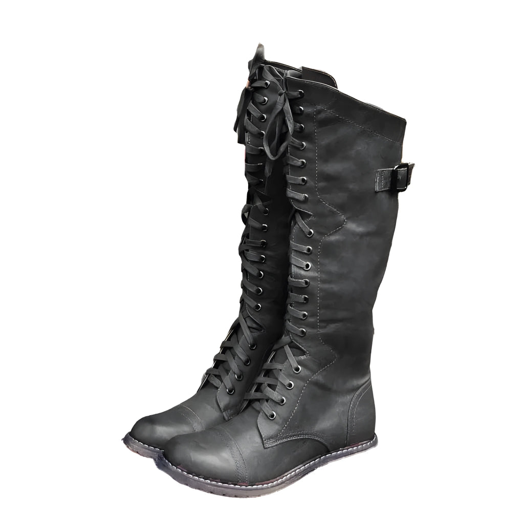 Women's black knee-high boots with cross strap design and knight boot styling