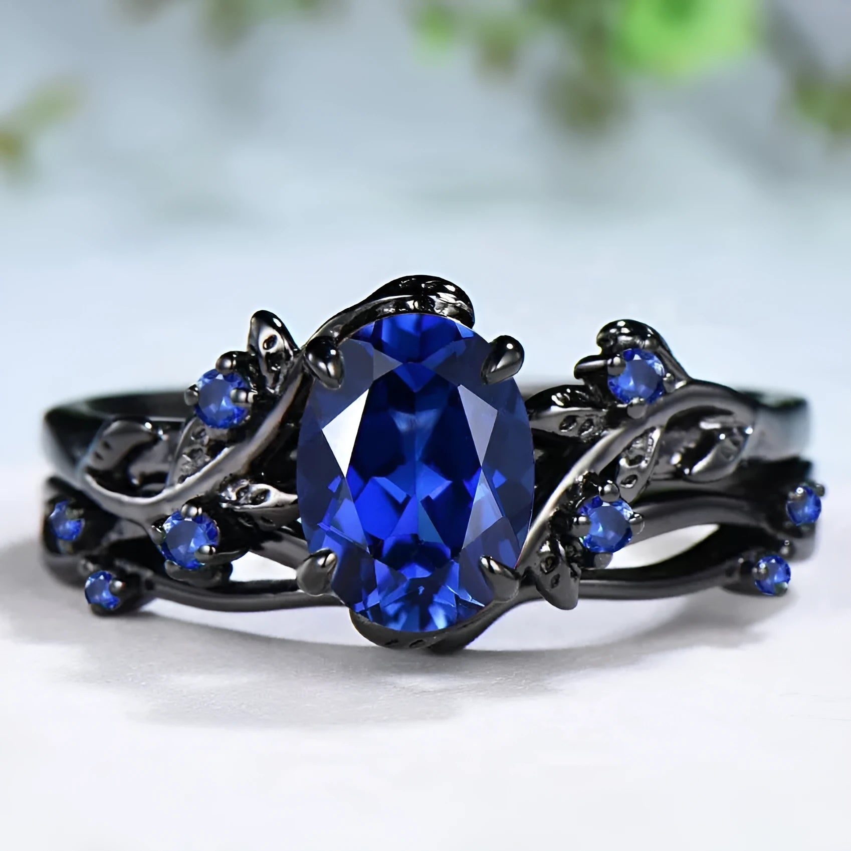 Black gun finish women's ring with navy blue rhinestone inlay on copper geometric band