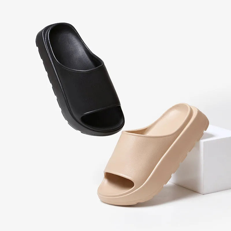 Women's beige fish mouth slippers with a thick 5.5cm light-coloured EVA sole on a wooden floor.