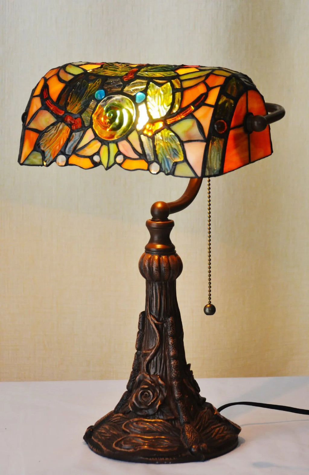 Tiffany stained glass table lamp with coloured glass shade on resin base for desk lighting