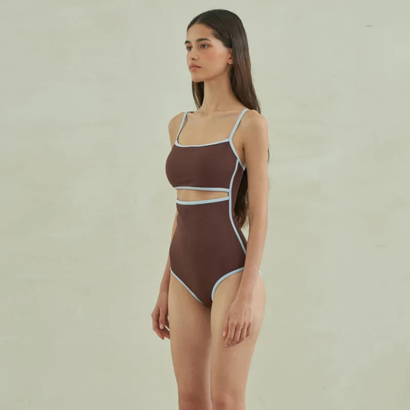 Brown women's one-piece triangle swimsuit on a hanger, showing front design.