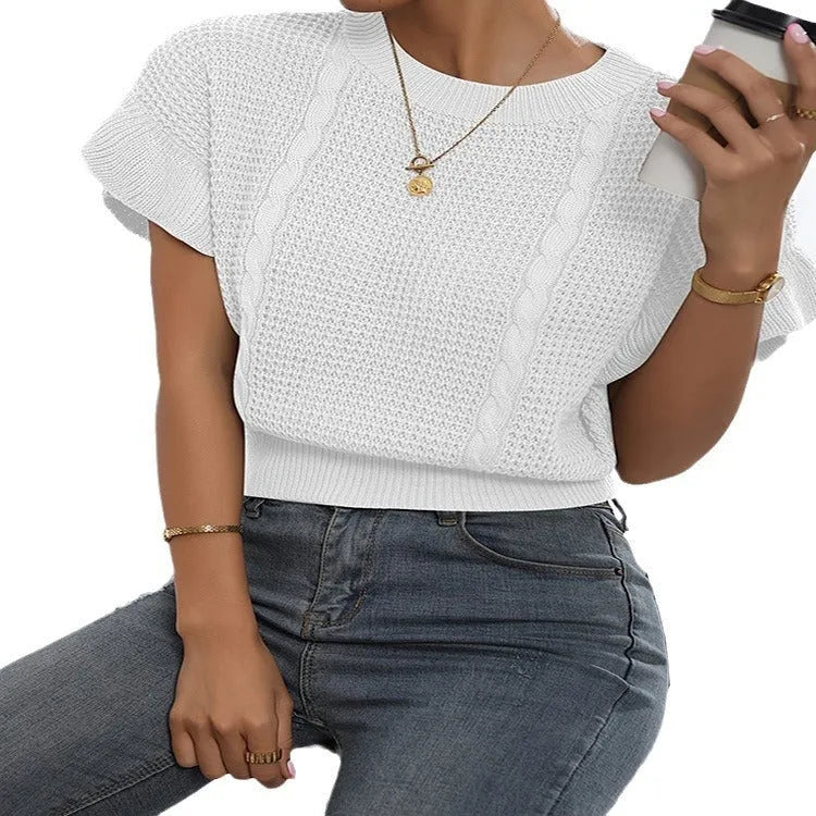 Loose fit knitted pullover with round neck and textured ruffled short sleeves in a neutral colour.