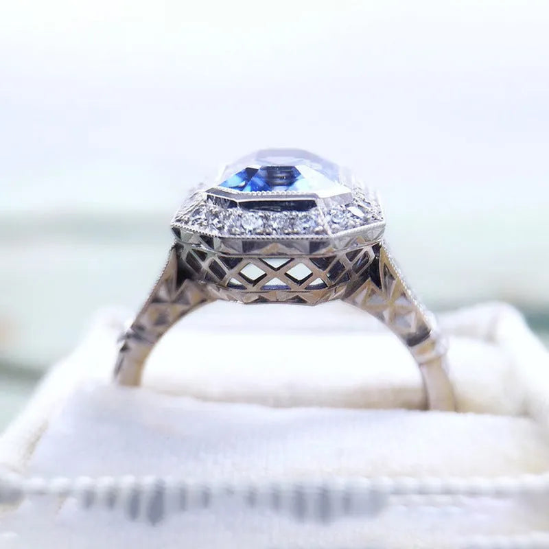 Blue long hexagon copper electroplated women's ring on plain background, sizes 6 to 10
