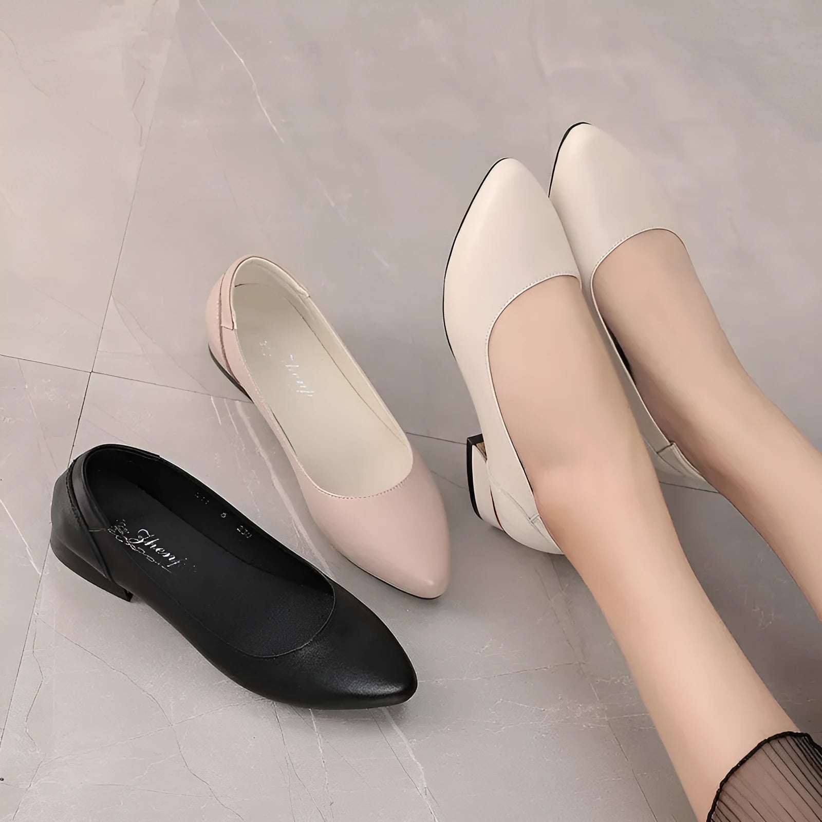 Beige flat pointed low-cut cowhide leather shoes with buckle closure and low heel on a white background
