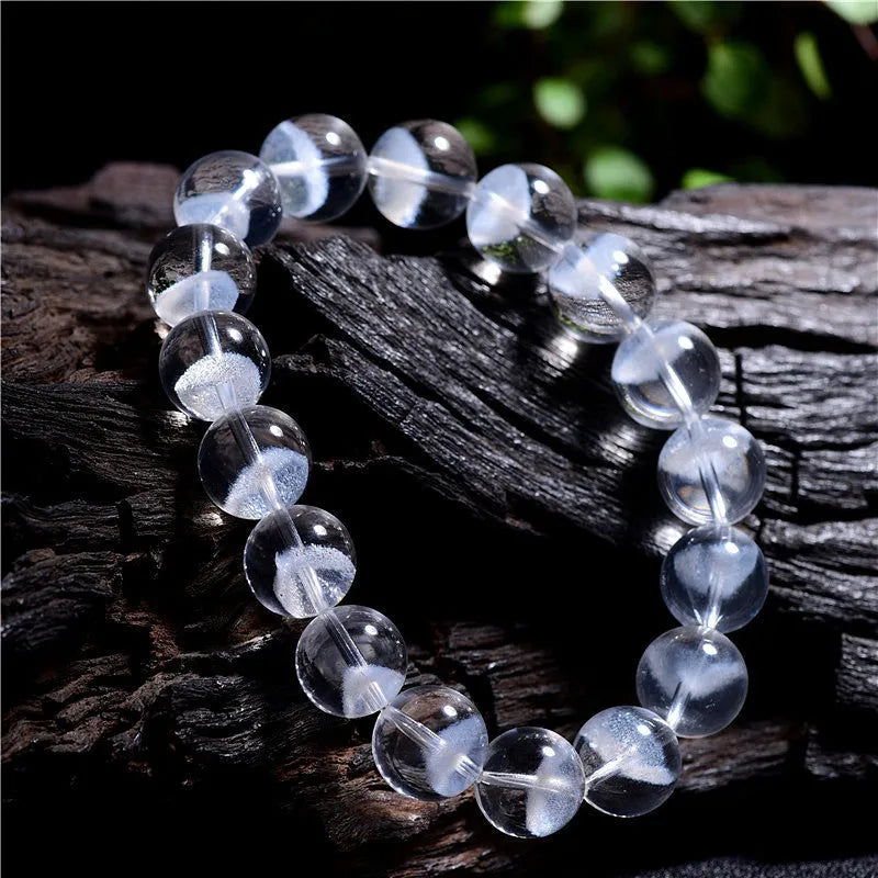 Women's natural white ghost pyramid crystal bracelet showing textured surfaces and ruyi charm detail