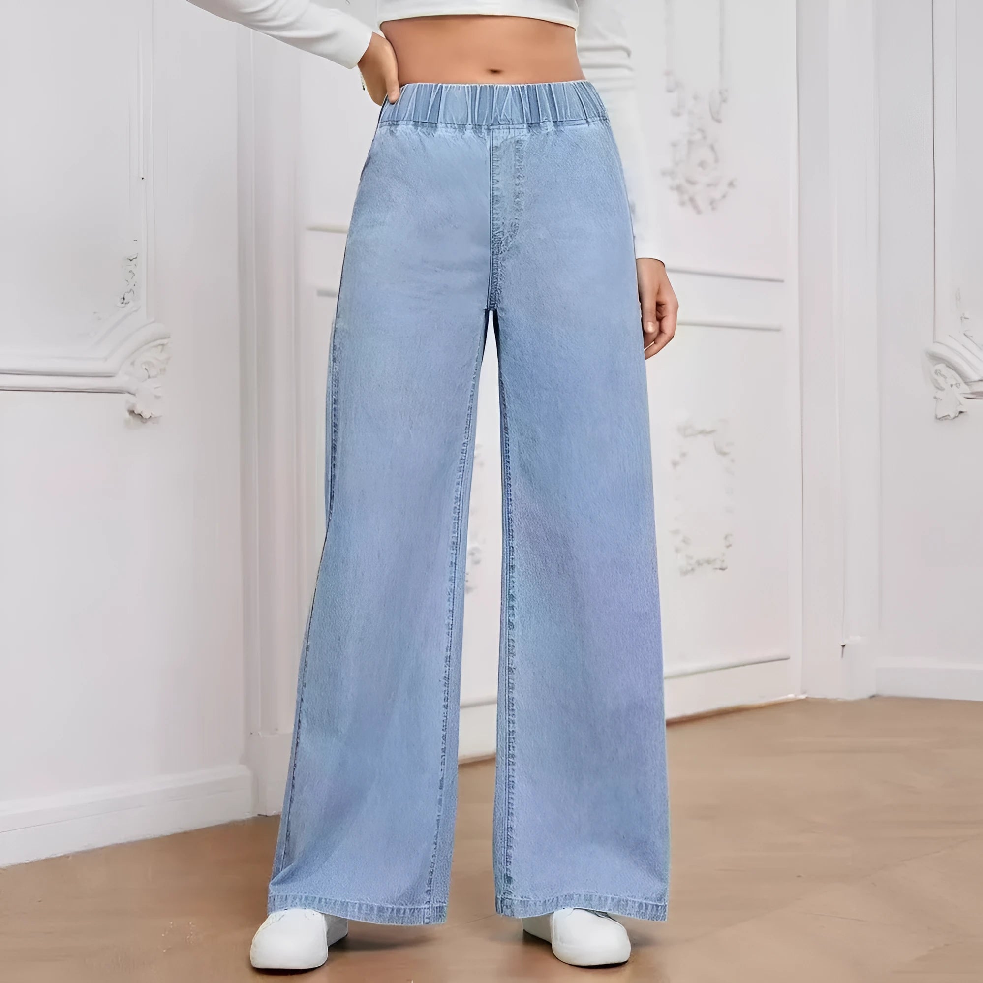 Light blue washed wide-leg denim jeans with straight cut and mid-rise waist on hanger