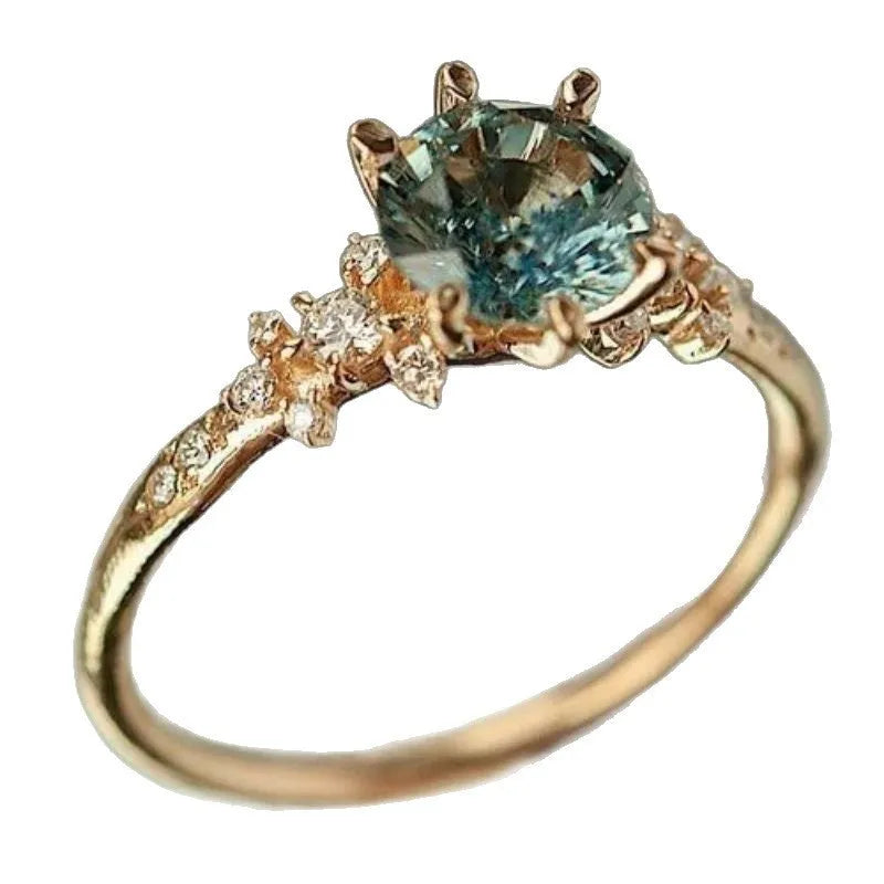 Geometric gold claw ring with inlaid zircon stones showing chamfered square pattern