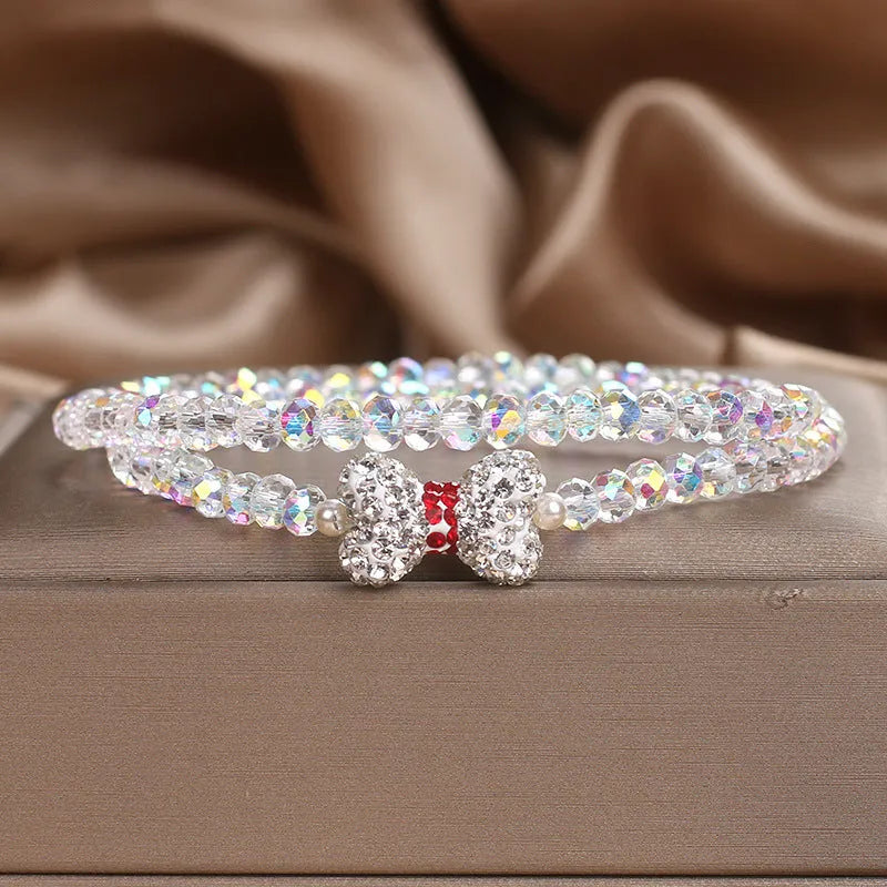 Double ring crystal bracelet with pearl and rhinestone accents on light background