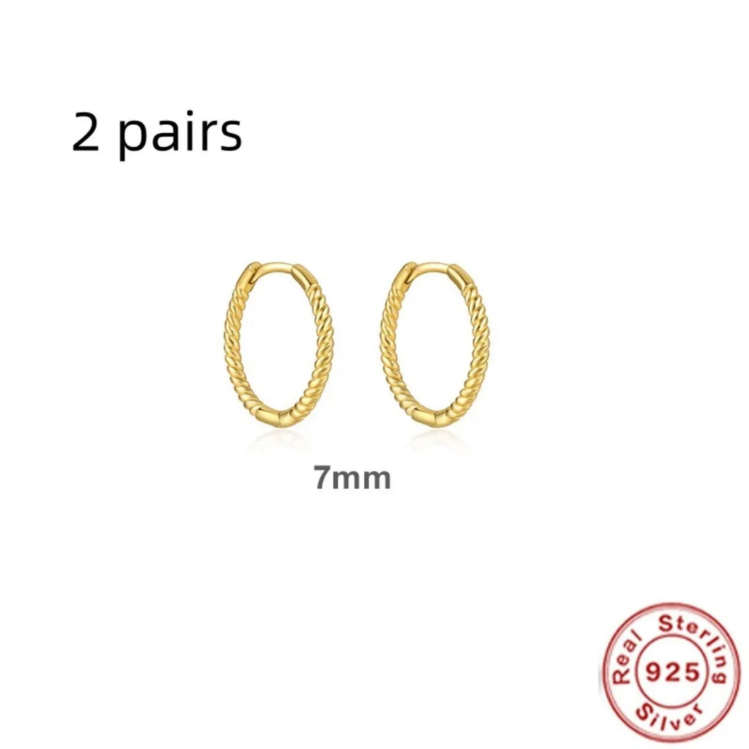 A pair of twisted string round geometric earrings made from Sterling Silver, shown in a gold electroplated finish.
