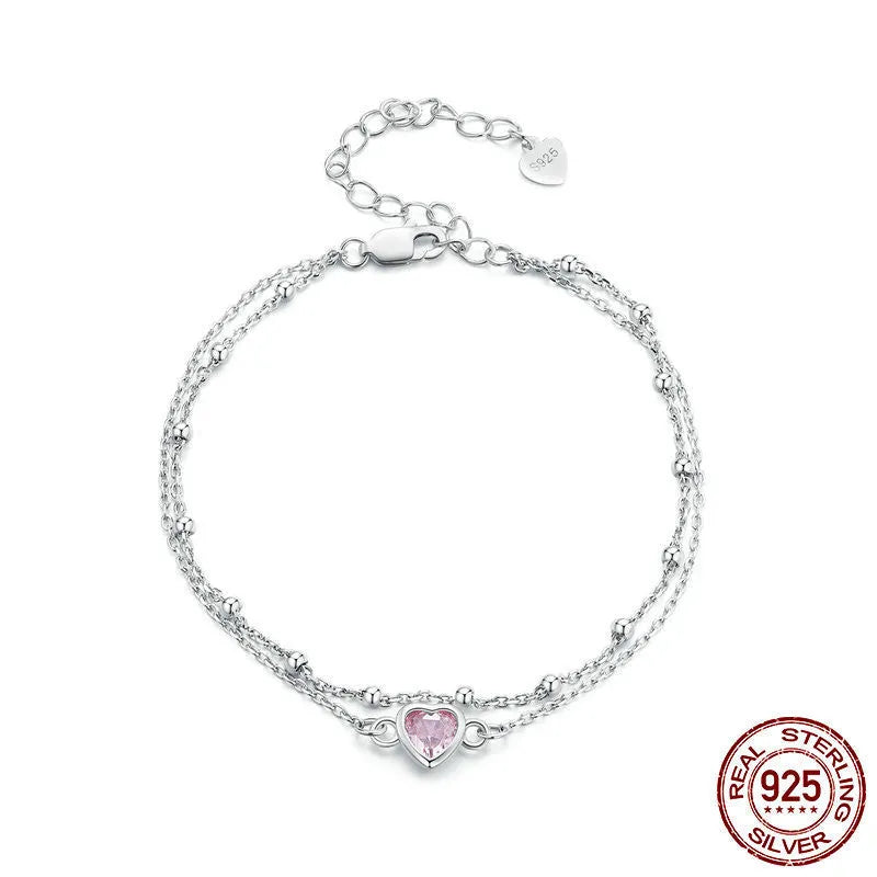 Sweet girlish heart-shaped sterling silver bracelet with adjustable chain on a white background.