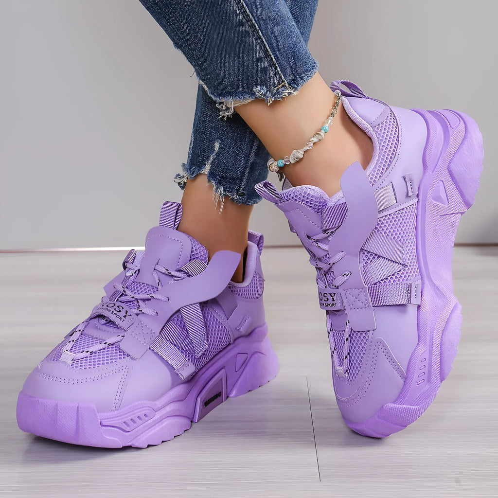 Women's purple platform mesh dad shoe with animal pattern and lace-up front on a white background.