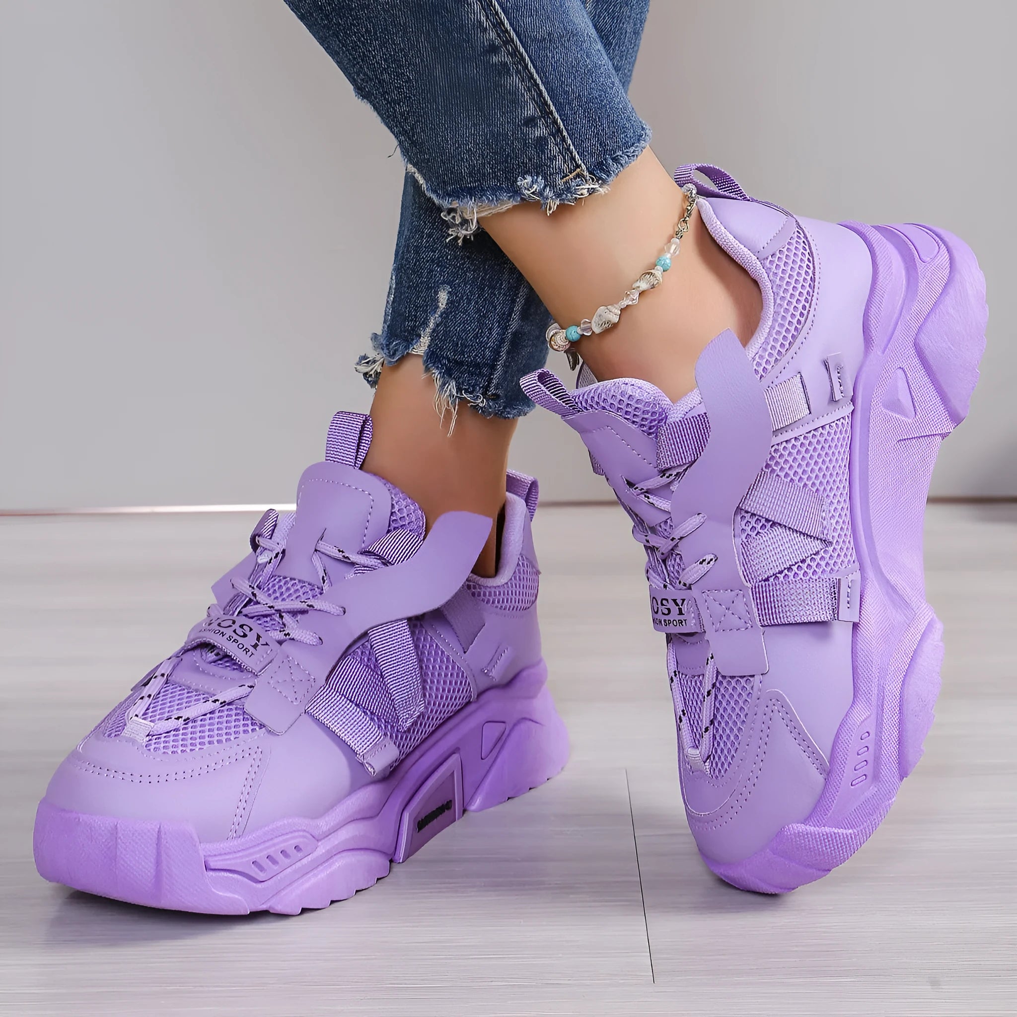 Women's purple platform mesh dad shoe with animal pattern and lace-up front on a white background.