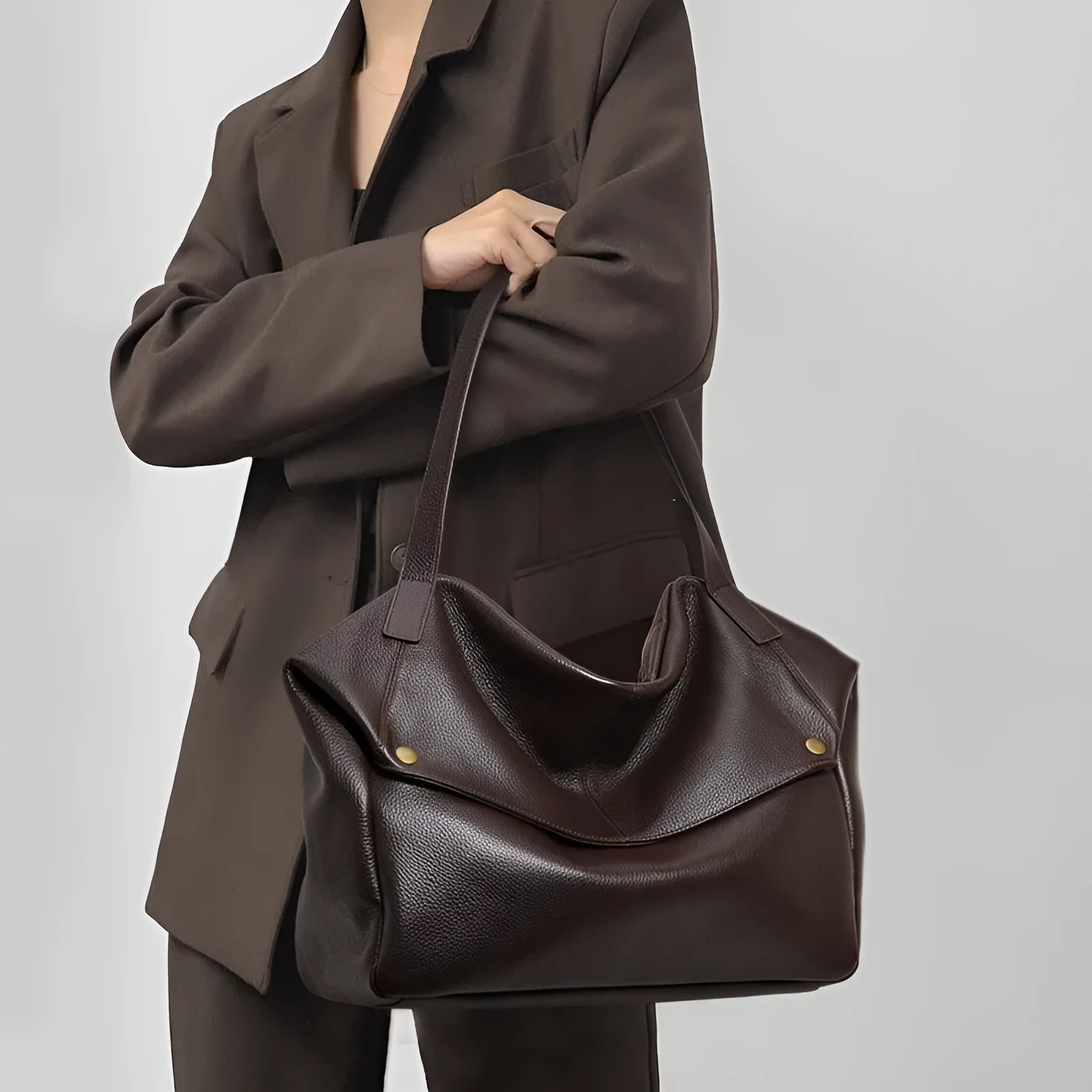Brown genuine leather women's shoulder bag with horizontal square design showing interior zippered compartment