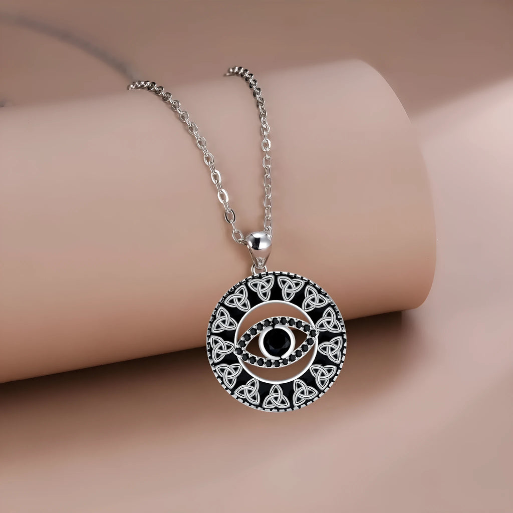 Copper Devil's Eye pendant necklace with cross chain and electroplated finish on display