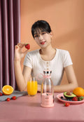 Handheld USB rechargeable mini juicer in pink with PC food grade plastic liner and four cutter heads