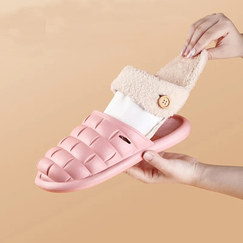 Women's pink and grey plaid EVA slippers with a detachable upper and plush lining on a wooden floor.