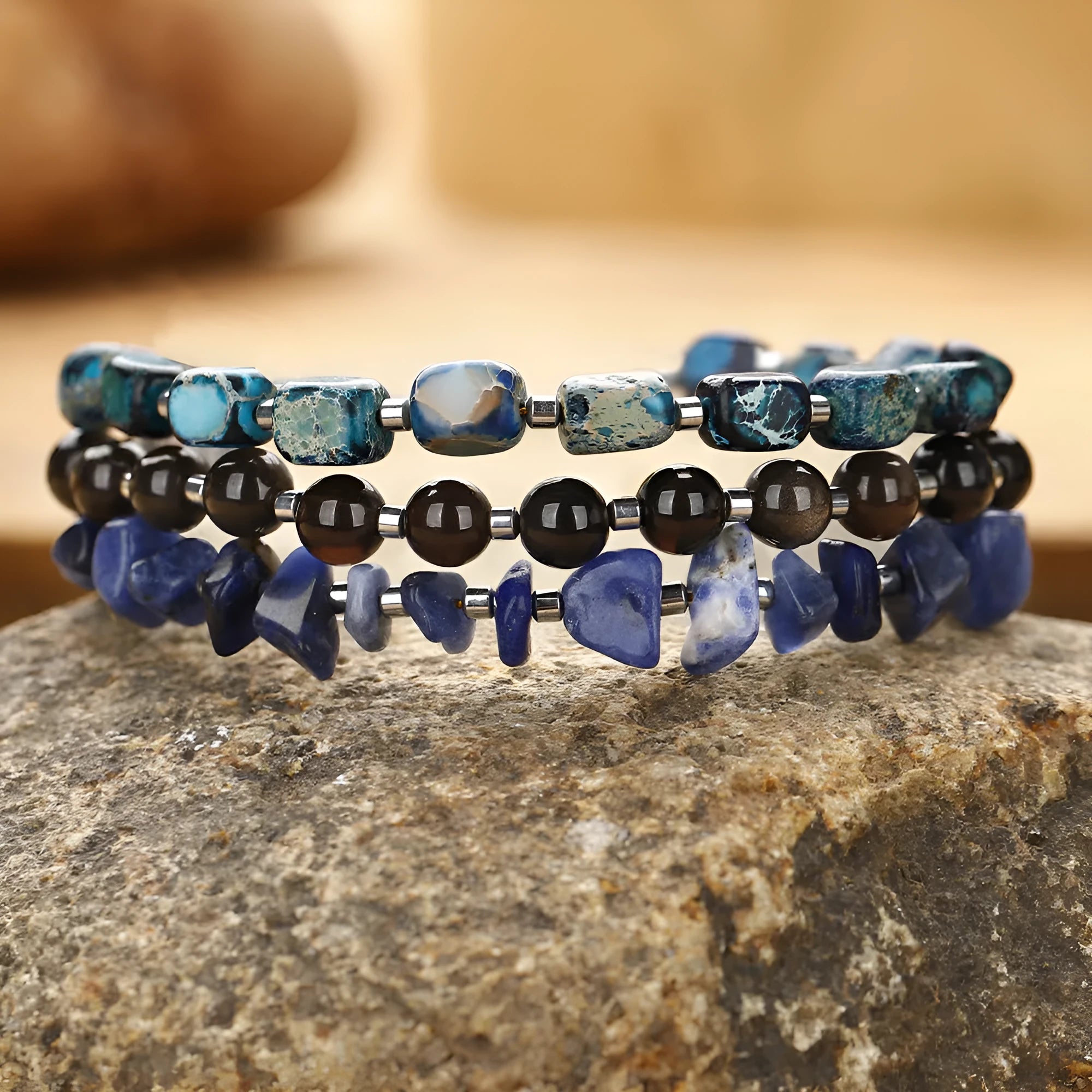 Blue multi-layer hand woven bracelet with Fang Hui stone and gold obsidian geometric texture on white background