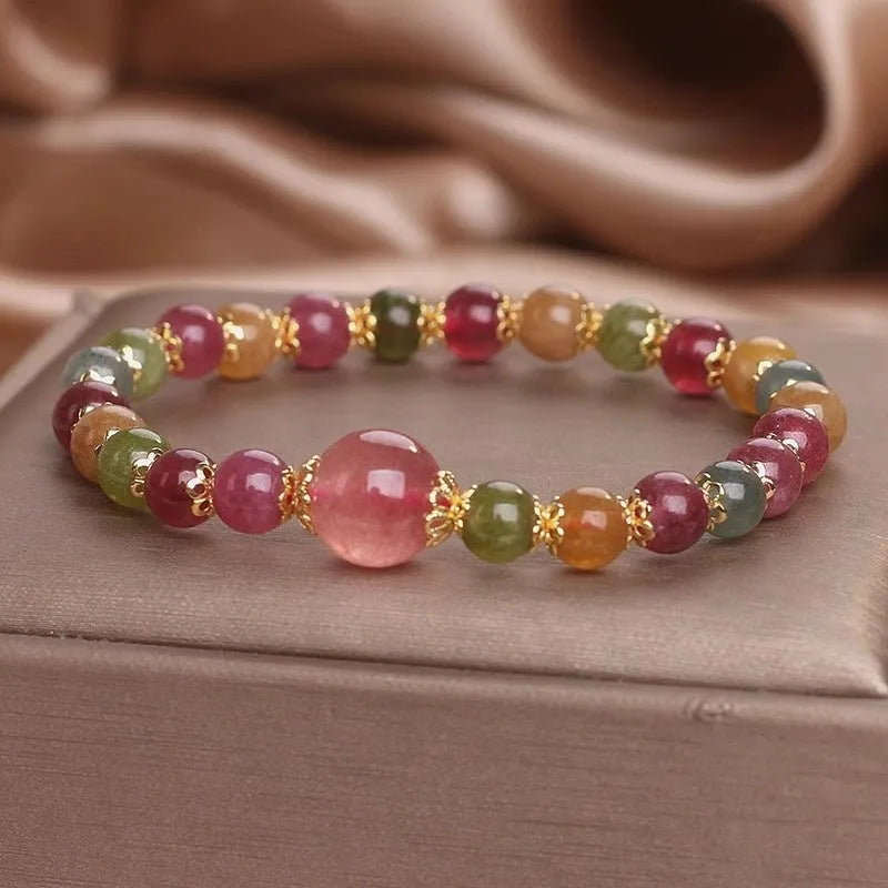 Natural tourmaline and strawberry quartz 10mm round bead unisex bracelet on neutral background