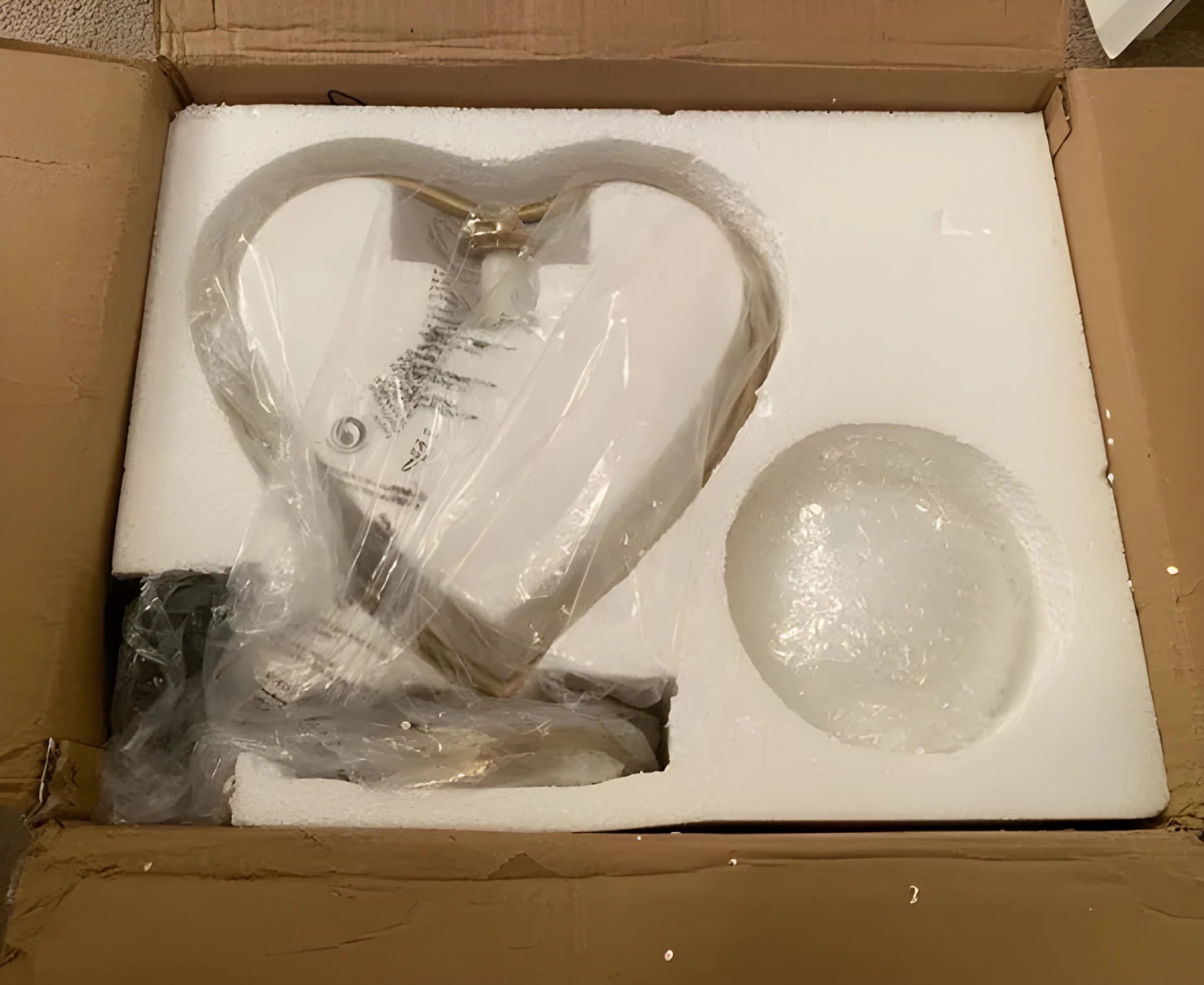 A single heart-shaped table lamp on a surface, showing its decorative design.